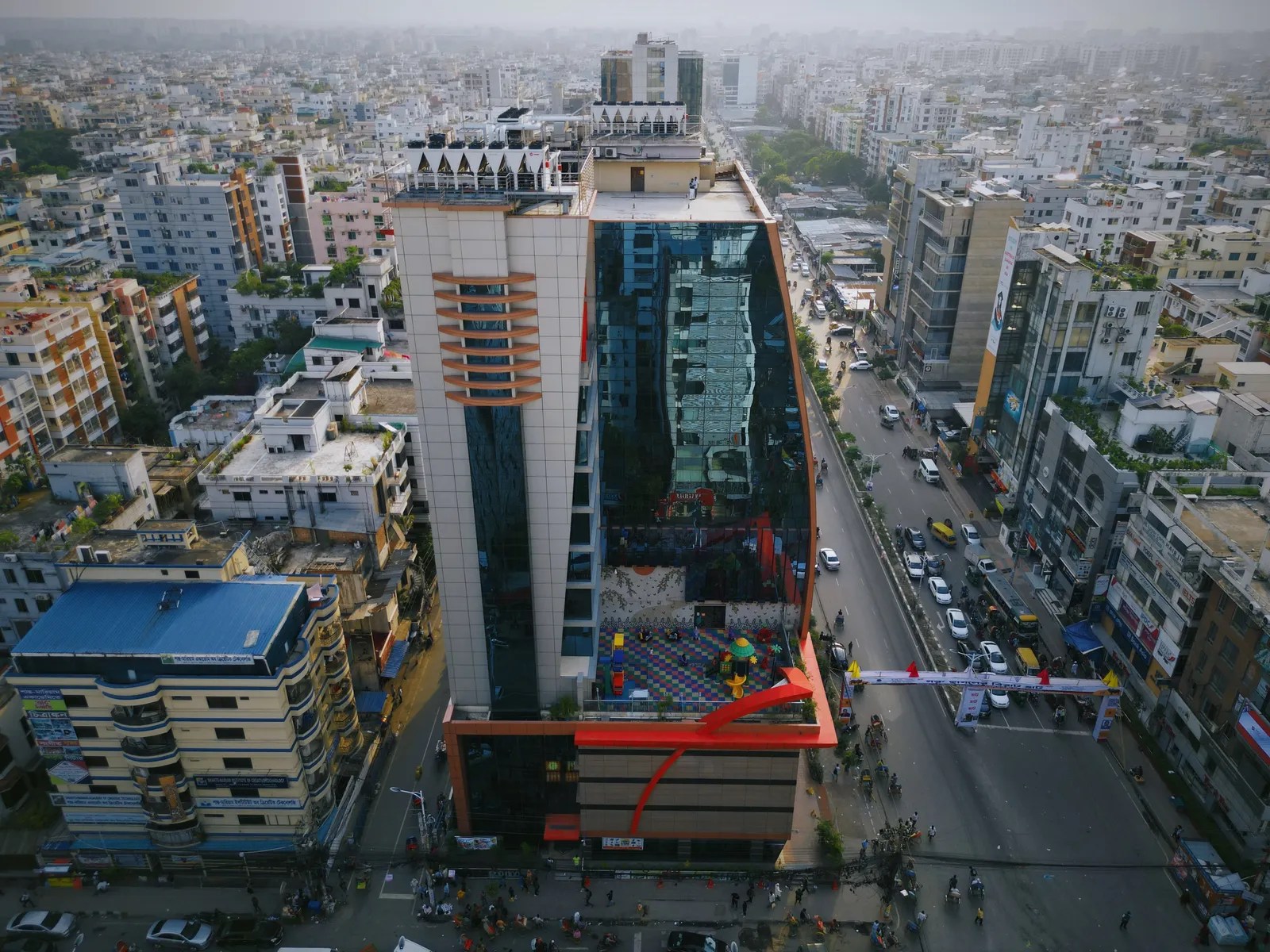 Side view of ZamZam Tower showing the glass facade and children's play area