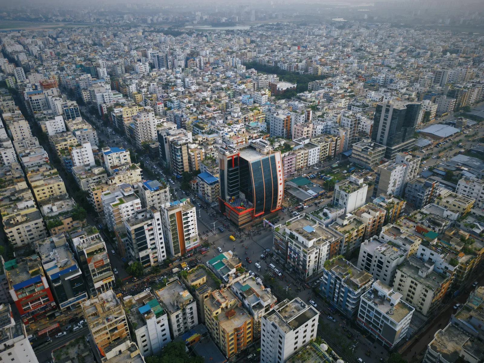 Wide aerial view showing ZamZam Tower's prominent position at the Sector 13 roundabout in Uttara
