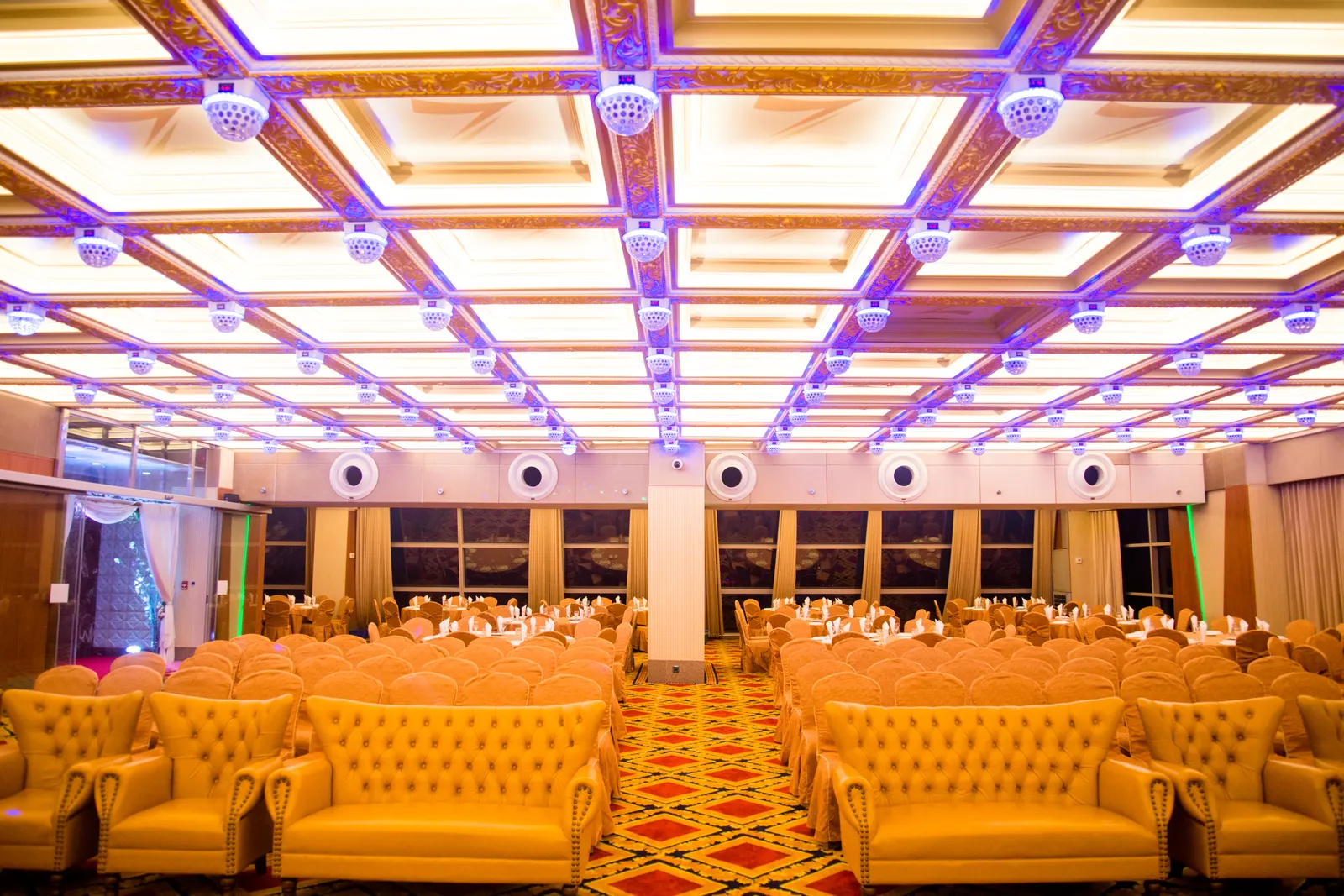 Grand banquet hall inside ZamZam Convention Center with golden seating and ornate ceiling